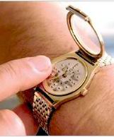 One Finger reading an opened hand watch