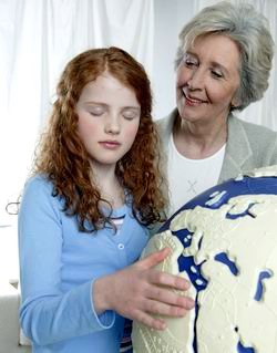 blind girl next to the relief globe